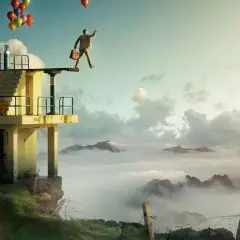 En man med portfölj och ballonger står på en dykplattform över moln. Erik Johansson fotograf.