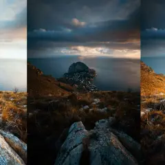 En dramatisk vy över en kuststad vid foten av ett berg, med moln som skapar en känsla av **high dynamic range**.