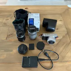 Här ligger en Panasonic GM1 med tillbehör: objektiv, laddare, batteri och fodral. Perfekt för den som vill fotografera.