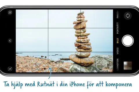 En liggande bild på en iPhone visar en stenhög vid havet. Rutnätet på skärmen hjälper till att komponera bilden.