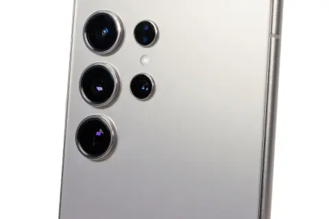 Närbild på baksidan av en silverfärgad telefon med flera kameralinser, en del av samsung s21 kamera-systemet.