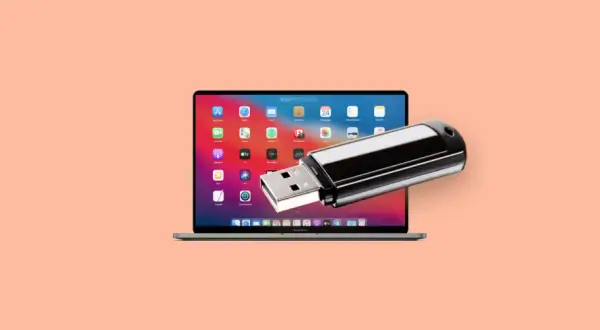 En MacBook Pro med en USB-sticka som sticker ut från skärmen, perfekt för att spara bilder på usb-minne.
