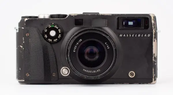 En sliten men ikonisk Hasselblad XPan-kamera med vidvinkelobjektiv. Den har sett bättre dagar men är redo för nya äventyr.