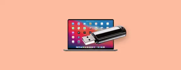 En MacBook Pro med en USB-sticka som sticker ut från skärmen, perfekt för att spara bilder på usb-minne.